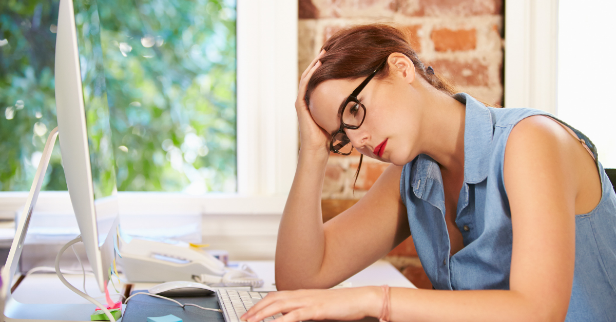 Stressed woman at computer desk