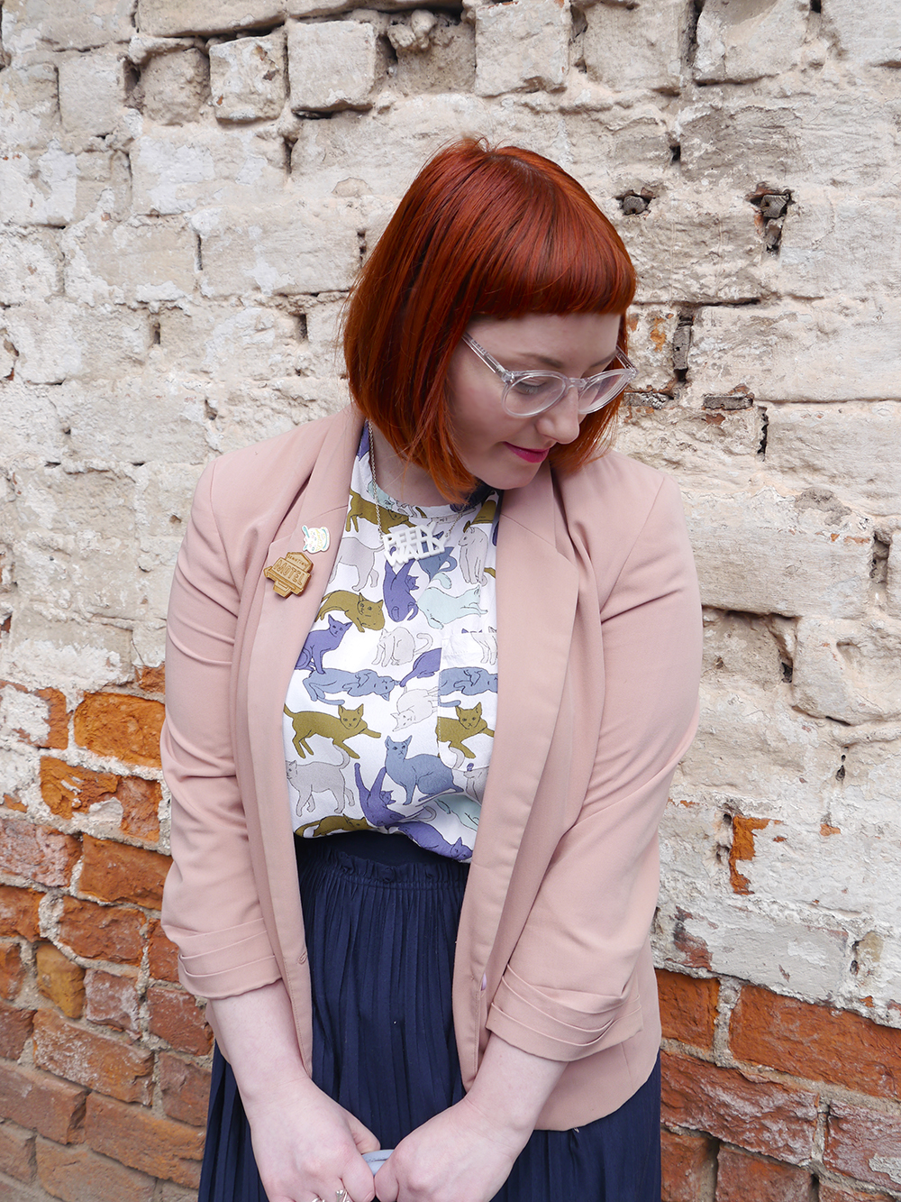 Saturday Shopping Style what Helen wore, red head, See with Iolla, Iolla clear glasses, clear spectacles, Scottish blogger, scottish fashion blogger, Dundee blogger, Dundee event, Dundee, cat lady, crazy cat lady outfit, cat top, H&M outfit, blue skirt, pleated navy skirt, charity shop shoes, white lace up boots, pink blazer, Lucky Dip Club pin, Kate Rowland wooden brooch, Bonnie Bling necklace, Scottish slang necklace, peely wally necklace, Scottish street style, brick wall background, cat print top