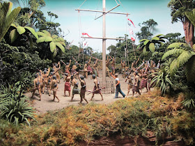 Diorama of a group of 19th-century Maori  around a flagpole in the bush