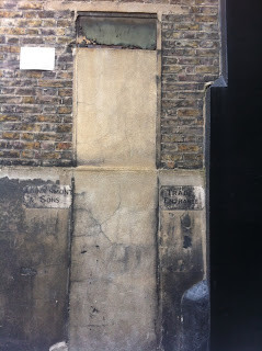 Ghost sign, in a mews entrance near Paddington, London