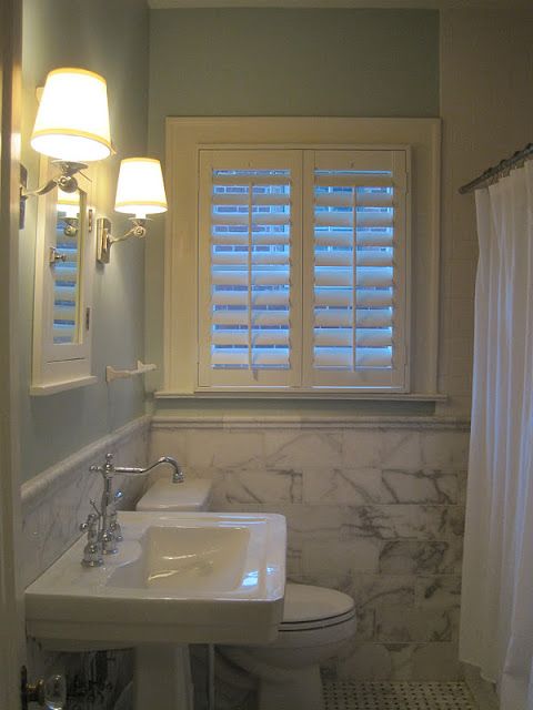Beautiful bathroom with white plantation shutters
