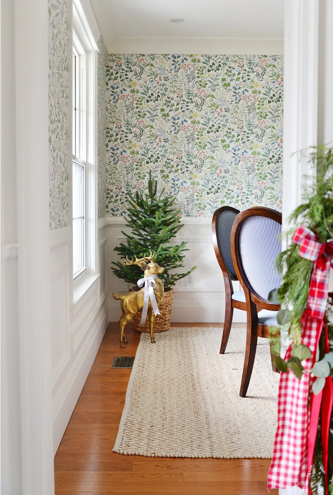 floral wallpaper in dining room, small christmas tree in basket, brass dear