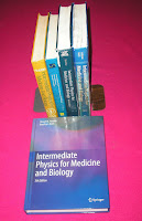 A photograph of all five editions of Intermediate Physics for Medicine and Biology.