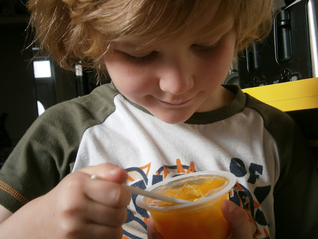 boy eating fruit in jelly
