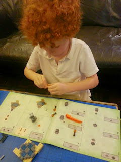 Boys building LEGO Minecraft set 21117 - The Ender Dragon set