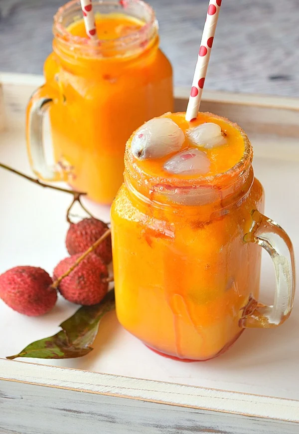 Mason Jar with refreshing Mango Lychee Mocktail , topped with lychee
