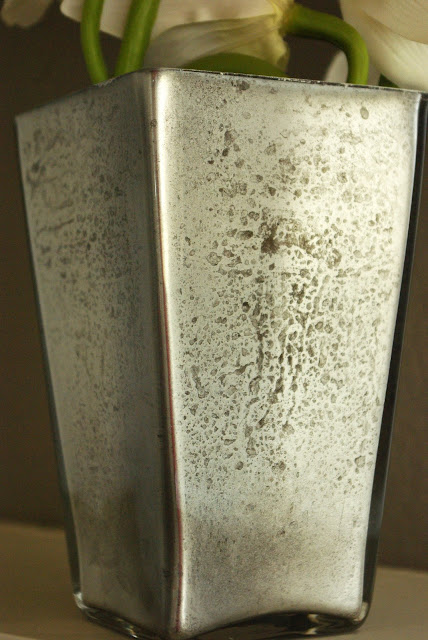 edges of mercury glass painted and faux rust stains added to vase