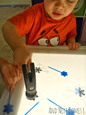 K hammering snowflakes on the light table from And Next Comes L