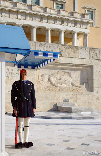 Presidential Guard (Evzones) with the traditional winter uniform at the Tomb of the Unknown Soldier in front of the Hellenic Parliament. Constitution Square Platia Sintagmatos of Athens. Presidential Guard (Evzones) with the traditional winter uniform at the Tomb of the Unknown Soldier in front of the Hellenic Parliament. Constitution Square Platia Sintagmatos of Athens.