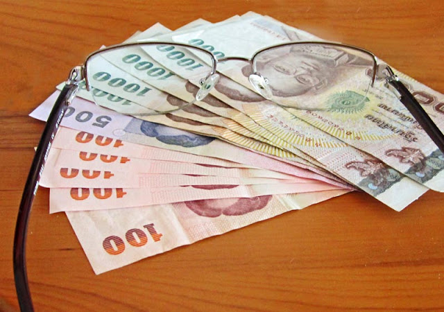 Baht notes and spectacles