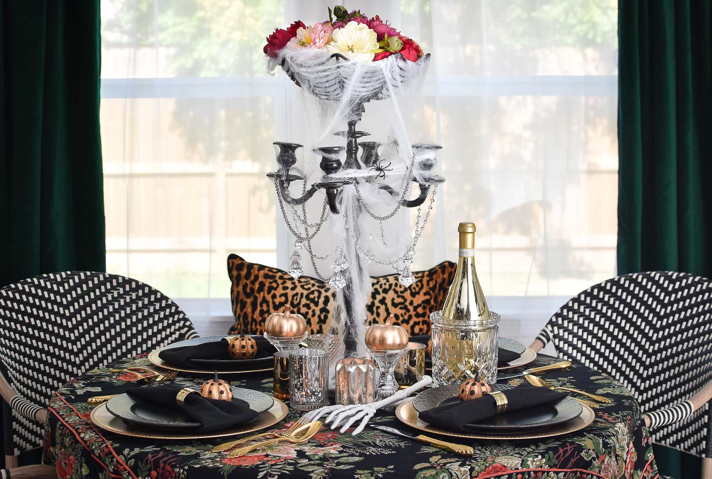 Glam Halloween Tablescape- A candelabra and dollar store supplies create a chic and spooky centerpiece for Halloween or day of the dead entertaining. | #diningroomdecor #diningroomdecorideas #halloweendecor #dollarstoreDIY #dollarstorecrafts #halloweenDIY #tablescapes #centerpieces A chic Halloween tablescape.