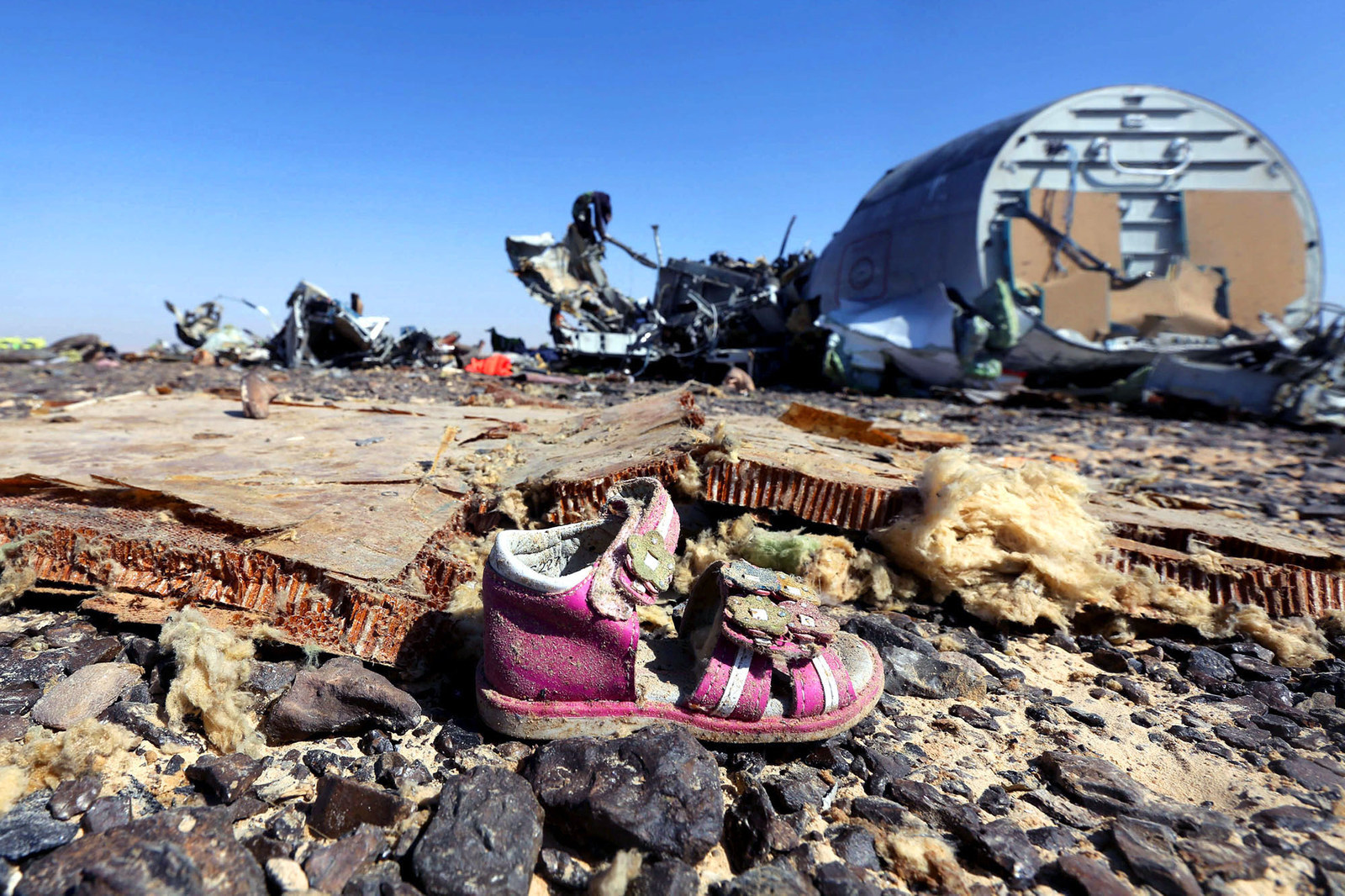 70 Of The Most Touching Photos Taken In 2015 - 70 Of The Most Touching Photos Taken In 2015 - A child's shoe lays by the wreckage of a Russian airliner which crashed in Egypt, killing all 224 on board. Russian and Western governments believe it was brought do