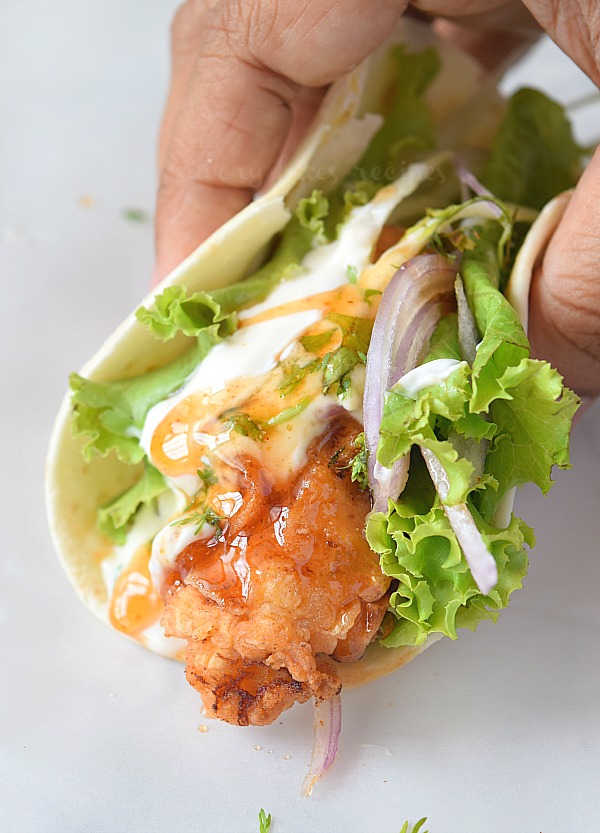 crispy fried chicken tacos with slaw,chipotle crema and honey chili sauce