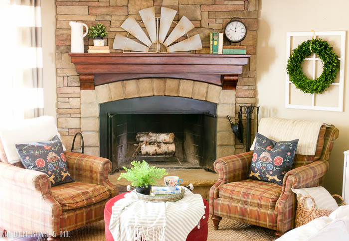 Spring decor with windmill, stone fireplace, and striped drapes