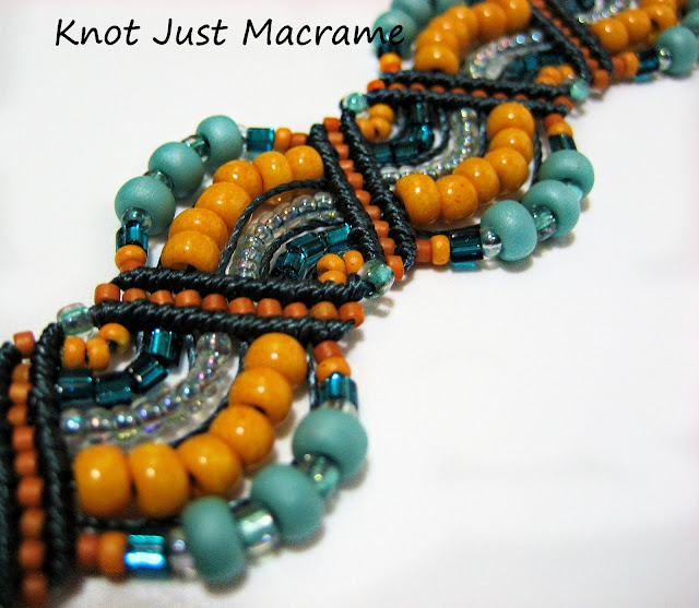 Micro macrame bracelet in deep blue and marigold.