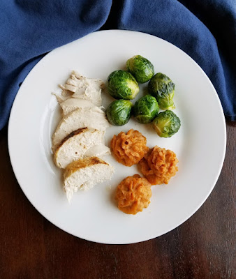 These duchess sweet potatoes add a little pizzazz to your plate, but they are really simple to make. They would be a fun way to change up your Thanksgiving or Christmas meal, but are delicious any time! looking down on round dinner plate with duchess sweet potatoes, turkey and roasted brussels sprouts