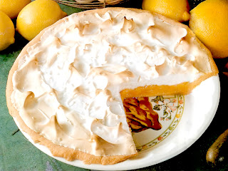 Classic meringue pie with an orange and lemon custard filling over a pastry base served topped with a baked egg white meringue