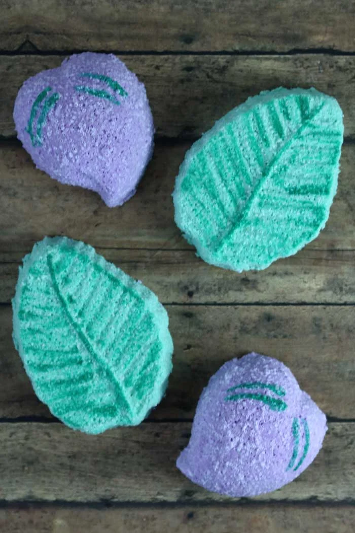 How to make bath bombs without cornstarch.  This simple natural bath bomb recipes is easy to make.  Make DIY homemade bath bombs with the best molds for best results.  Get ideas for easy bath bombs made with cute pineapple, flower, and plum molds.  These fizzy bath bombs are fun to make and fun to use.  If you need bath stuff diy and diy bath stuff recipes, check this out.  How to make bath bombs with Epsom salts.