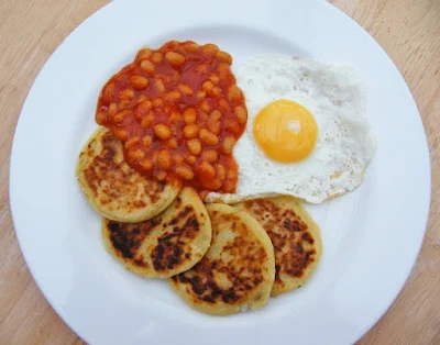 Scottish Tattie Scones on a plate with a fried egg and baked beans