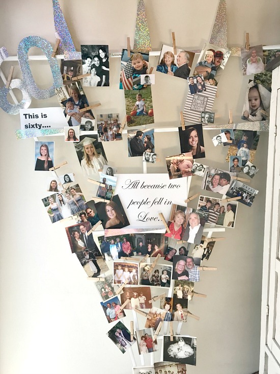 Garden trellis filled with photos from the couple on the bottom to grandchildren on the top