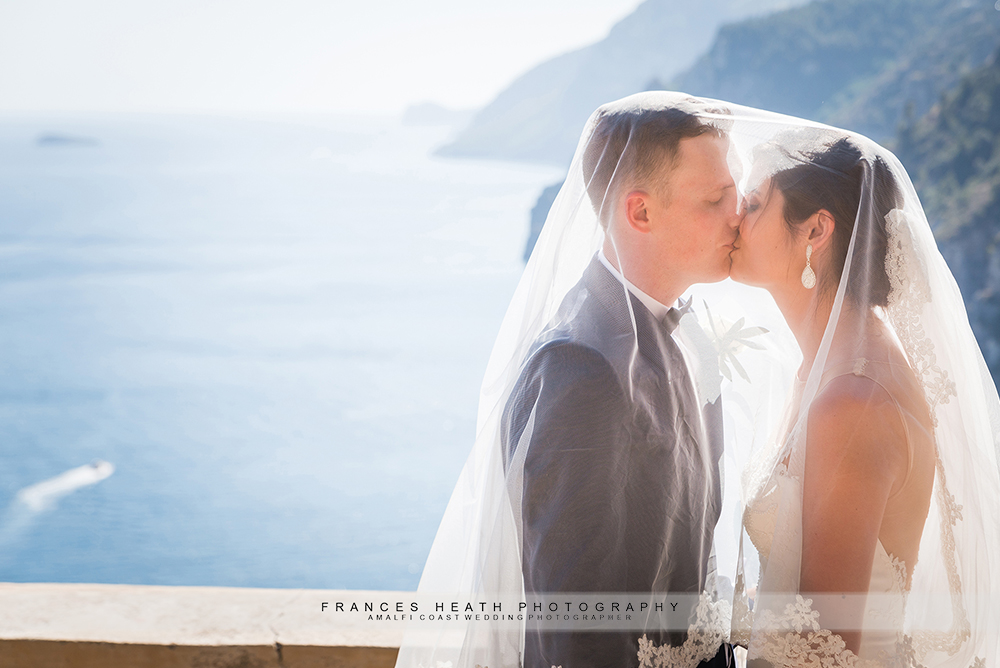 Sunny wedding day in Positano bride and groom underneath veil