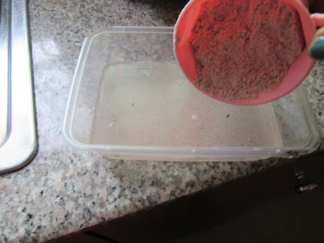 Mixing guinea corn flour with tap water