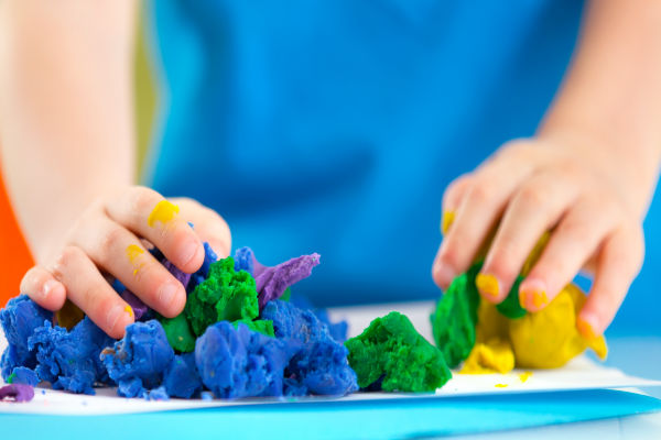 Make play dough from Kool-aid!  This play dough recipe is taste-safe and requires NO COOKING! A great kids activity for all ages #playdoughrecipe #playdough #koolaidplaydoughrecipe #koolaidplaydough #playdoughrecipenocreamoftartar #playdoughrecipenocook #playdoughrecipeeasy #koolaidplaydoughrecipenocook #nocookplaydough