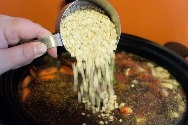 Barley being added to the slow cooker. 