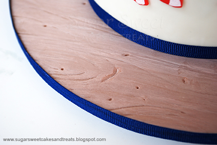 Baseball bat woodgrain effect on base board of cake made from fondant