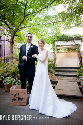 Bride and Groom in garden with Time Machine