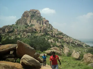 Hikers make way through the vegetation at the Kunti betta trek near Pandavpura