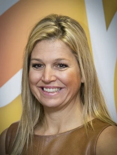 Dutch Princess Maxima attends the national school breakfast at the Zonnewijzer school in Leidschendam on a very windy day. she wore Natan dress