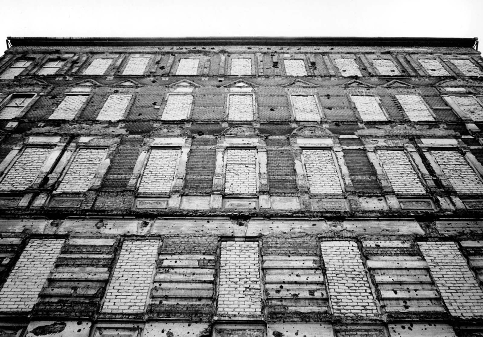 After East Germans jumped to freedom in the West, the windows of this building on the eastern side of the wall were bricked over. The building was later demolished. Photographed in 1962.