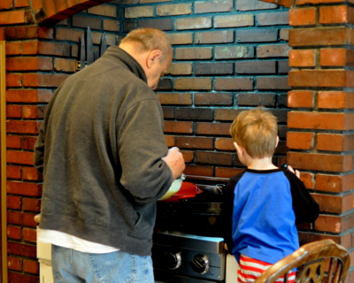 Grandfather and grandson making bear pancakes.