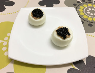 Eggs stuffed with foie and cheese with truffle pearls