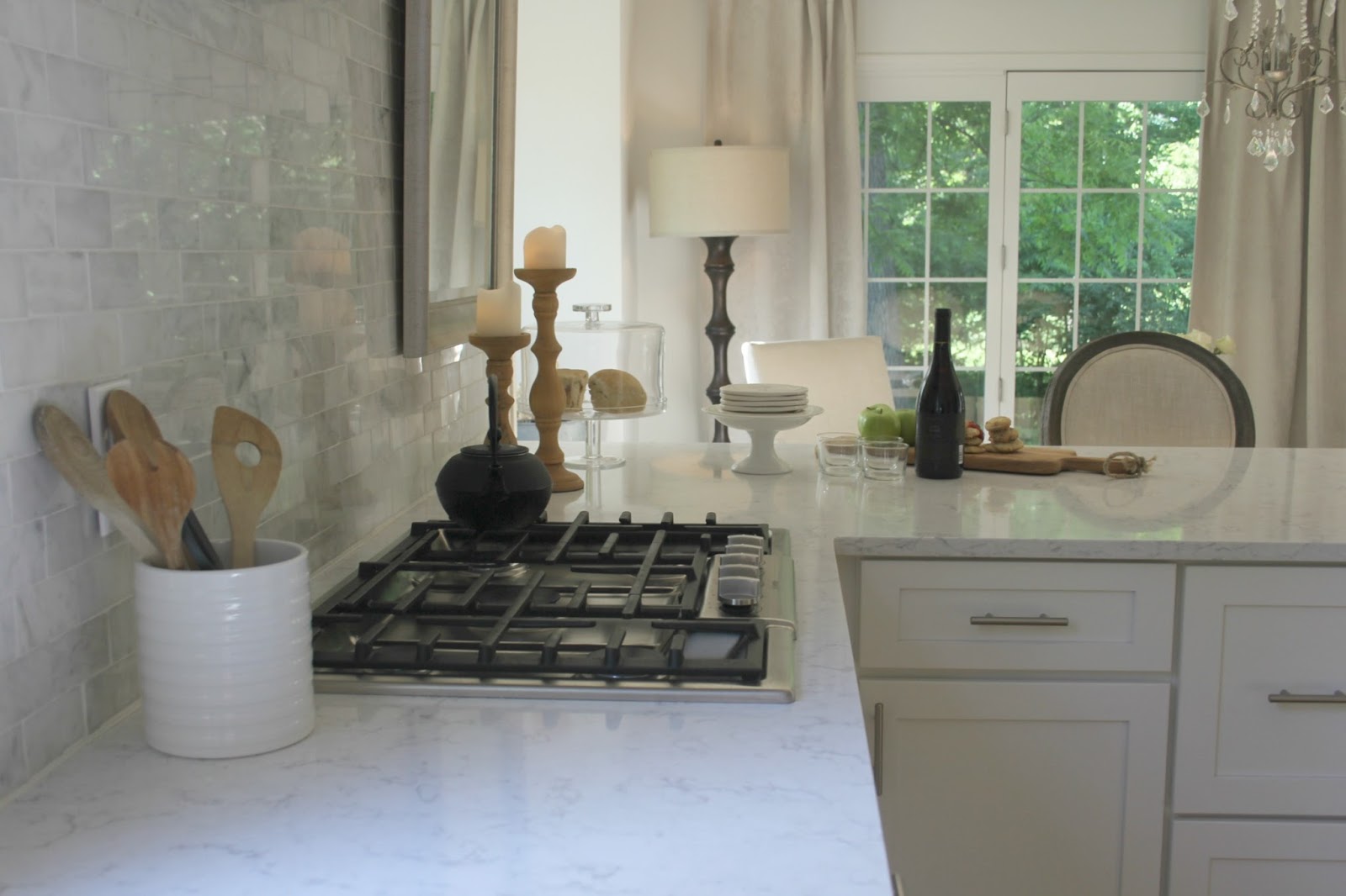 White modern farmhouse kitchen with marble subway tile and quartz countertop - Hello Lovely Studio