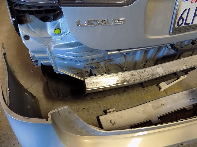 Damaged parts inside bumper cover on Lexus HS250h prior to repairs at Almost Everything Auto Body.