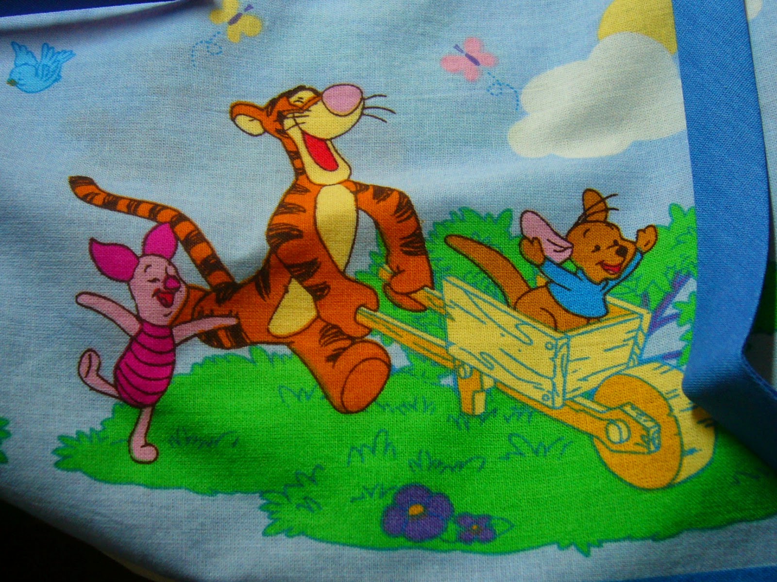 Tigger taking Roo for a ride with Piglet close behind.