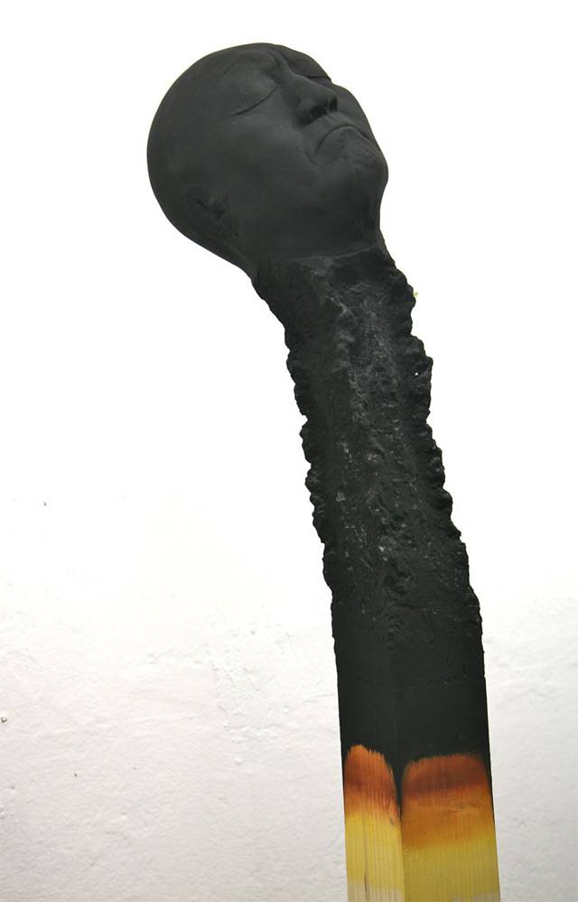 German artist Wolfgang Stiller acquired several head molds and large pieces of wood. After experimenting with the various components the artist struck on an idea to create several large-scale burnt matches where the charred remains of each tip appeared as the face of a human, a series he calls Matchstickmen