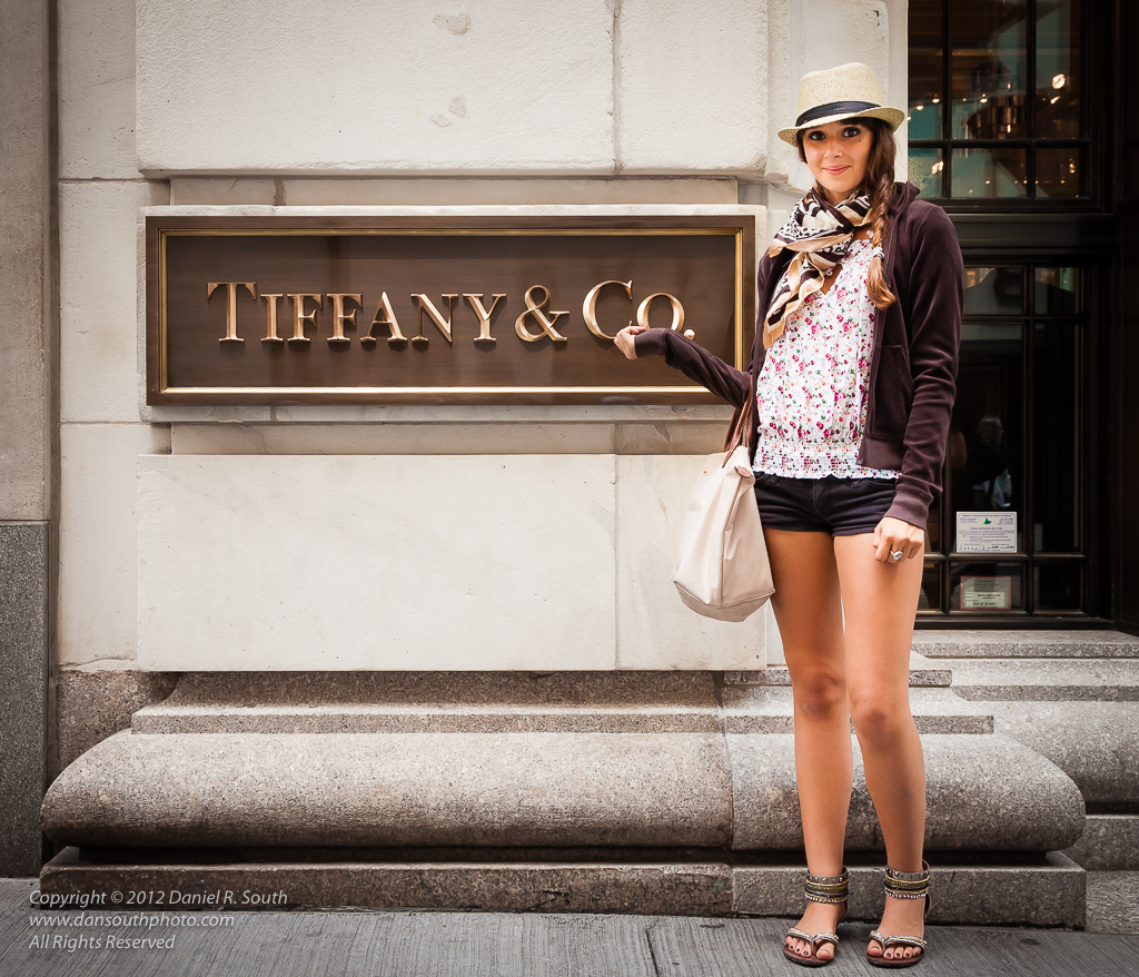 a photo of a stylish young woman posing in front of tiffany's new york store