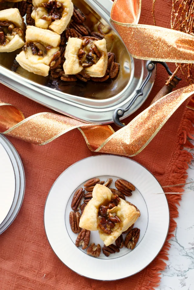 Maple Pecan Brie Bites are mini two-bite puff pastry cups filled with Brie and a sweet maple pecan sauce.  They are sure to be your new favorite holiday appetizer! #ad