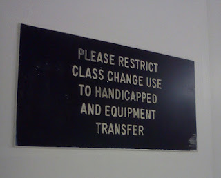 A sign on an elevator on my campus. It reads "Please restrict class change use to handicapped and equipment transfer"