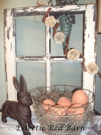 Eclectic Red Barn: Old window, cast iron bunny, wire basket filled with terracotta eggs and flower garland
