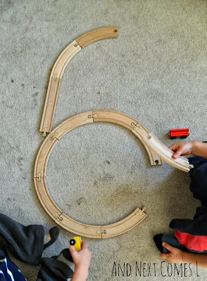 Learning numbers with wooden train tracks from And Next Comes L