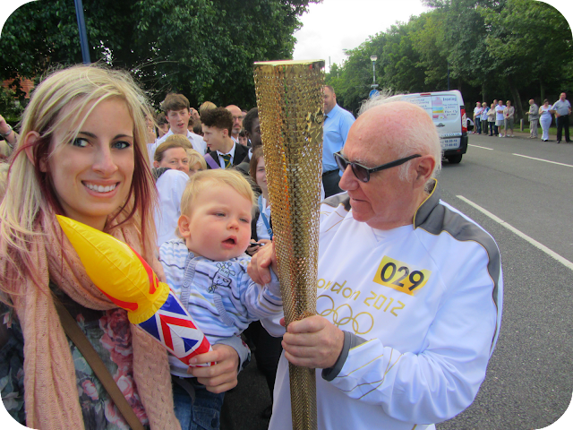 holding the olympic torch