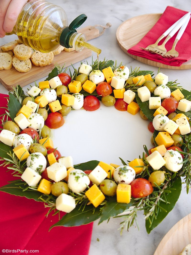 Christmas Wreath Cheese Platter Appetizer - an easy to assemble cheese board recipe that is very festive and perfect for holiday parties! by BirdsParty.com @birdsparty #holidaywreath #christmaswreath #cheesewreath #cheeseboard #cheeseplatter #holidaycheesewreath #christmascheesewreath #christmasappetizer #holidayappetizer #holidayrecipe #cheesewreathappetizer