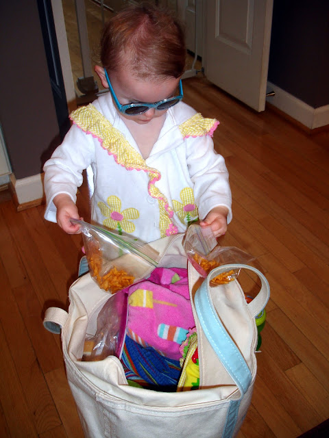 Large pool bag filled with snacks, towels, and toys