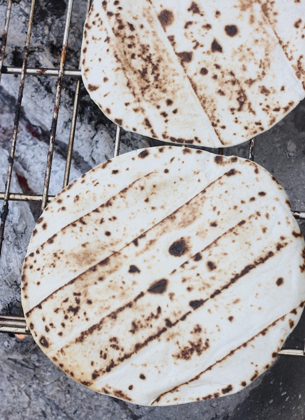 Naan bread cooking on campfire grill
