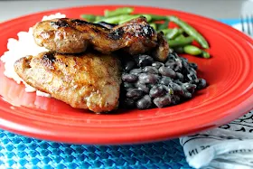 Grilled Jerk Chicken Thighs by Renee's Kitchen Adventures on a red plate with white rice, black beans and green beans