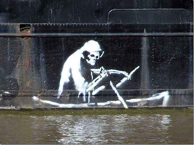 Banksy's version of the Silent Highwayman (1858) stenciled in white on the side of The Thekla in Bristol, UK just above the water line (April 2005)